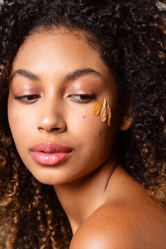 Testing makeup foundation on a woman's skin