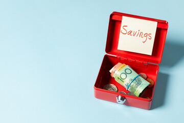 A 100 Australian dollar bill rolled inside a red box