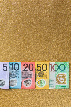 Australian dollars bills on a gold background