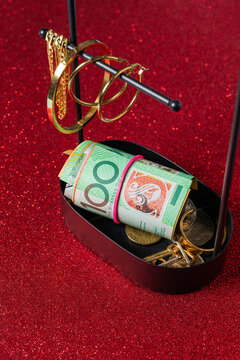 100 Australian dollar bill wrapped in a rubber band on a jewelry box