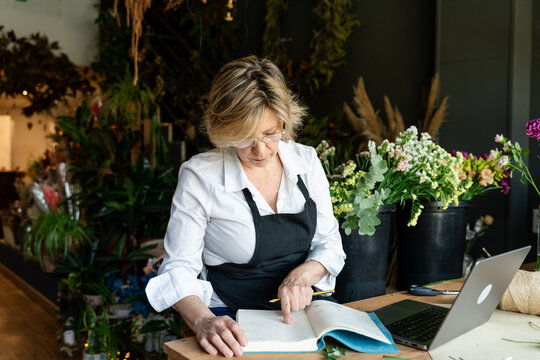 Florist reviewing orders in flower shop