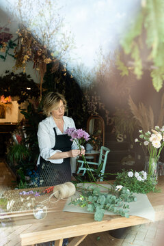 Florist arranging flowers in cozy shop