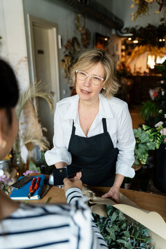 Florist processing payment in flower shop