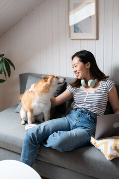 Young woman enjoying time with her shiba inu at home