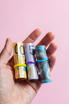 An anonymous hand holding Australian dollars money cash