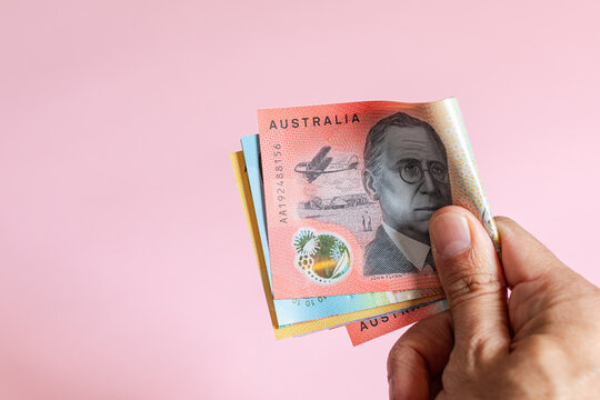 Anonymous hand holding an Australian dollars