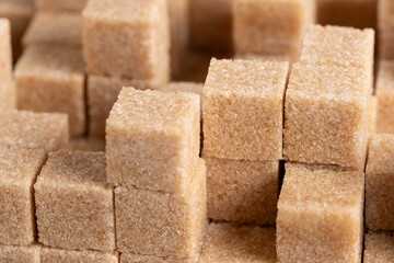 Close up of brown sugar cubes in a row. Whole background.
