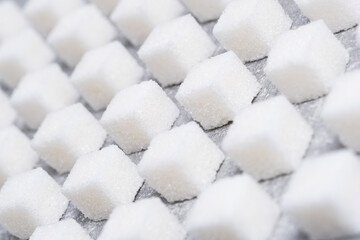 Refined sugar cubes are laid out in clear geometric lines.