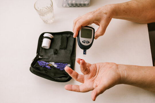 Person Monitoring Blood Glucose Levels Indoors
