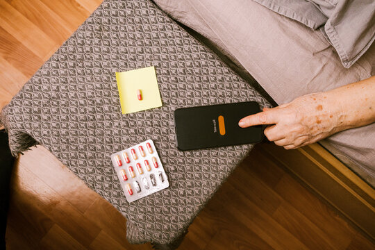 Elderly Person Managing Medication With Smartphone App