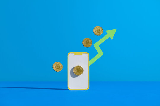 Green arrow and Mobile trading platform isolated on color background 