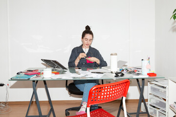 Designer Cleaning Glasses at Desk