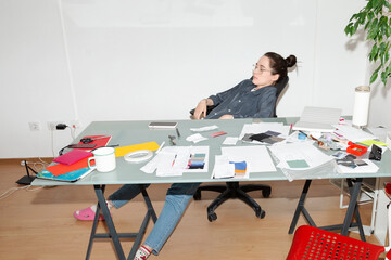 Tired Office Worker at Cluttered Desk