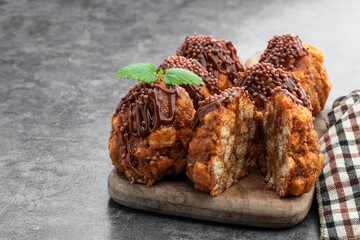 Milk chocolate glazed cookies on gray background