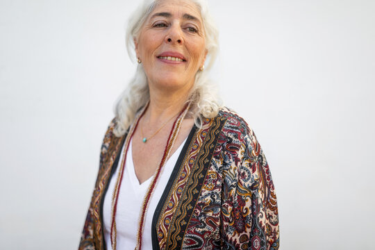 portrait of mature white-haired woman on white background