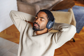 Man listening music and relaxing at home