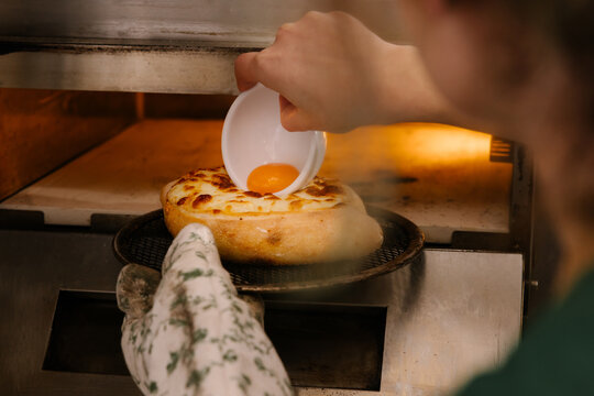 Adding the Finishing Touch to Khachapuri, Georgian Tradition