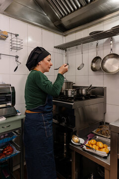 Chef sampling Georgian cuisine, a culinary moment captured.
