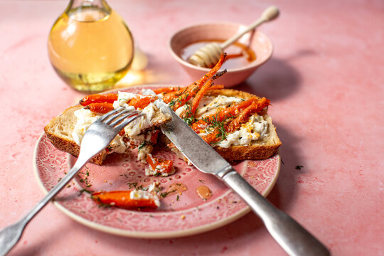 Pink plate with carrots on toast
