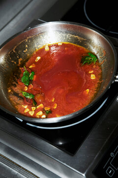 Tomato sauce with basil in a pan 