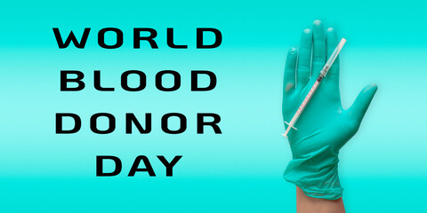 A hand holding a syringe with the words World Blood Donor Day written below it