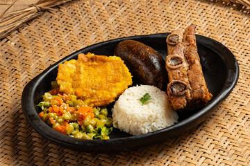 Peasant roast with baked pork rib, blood sausage, patacon, white rice and salad - Typical Boyacense food