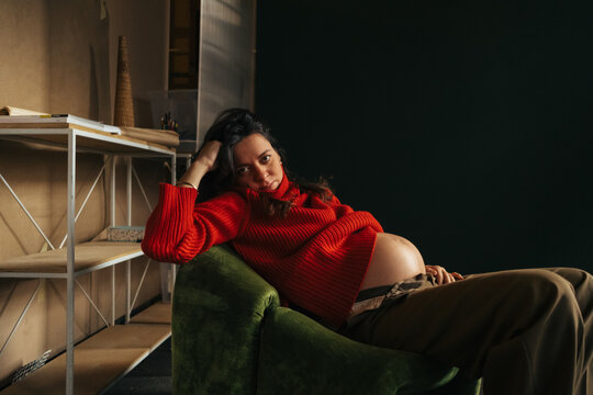 Beautiful Pregnant Woman Sitting in Studio