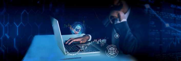 Thoughtful young african american businessman working on laptop in office