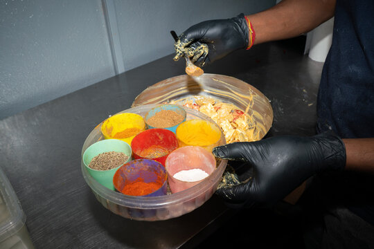 Kitchen Worker Adding Spices To Matar Paneer Mutter Masala