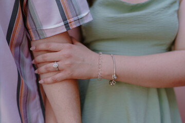 Engaged Couple close up shot of hand and arms linked