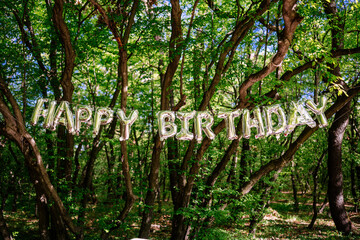 Happy birthday sign outside in forest