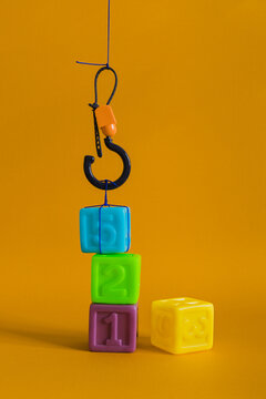 Сolorful plastic cubes with numbers lined up move with a hook