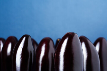Half cut egg plants aligned on blue background