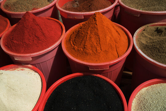 Colorful Assortment of Spices in Buckets at a Traditional Market Stall