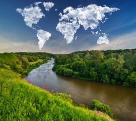 Fototapeta premium clouds in the form of a world map over a picturesque river. travel and landscape concept. spring meadow