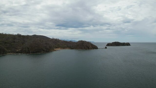 Pan across pacific ocean from Playa El Jobo to Isla Chancleta and the Playa Rajada in Costa Rica