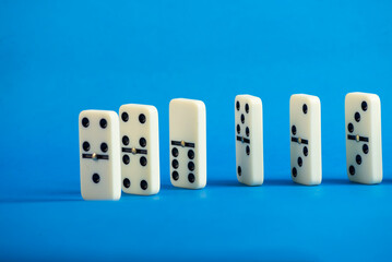 Dominoes with blue background, copy space and various angles.