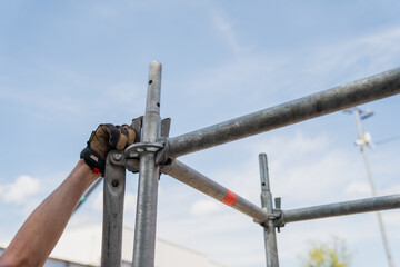 Building modular scaffolding systems with ringlock locking system, professional builders hand...