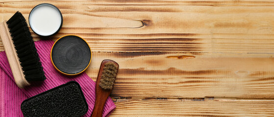 Brushes, sponge, napkin and shoe polish on wooden background with space for text