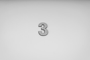 Number three in leather on yellow background (Black and white)