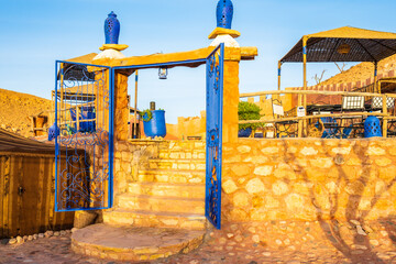 Swimming pool in traditional riad kasbah guesthouse at sunrise in Ait Ben Haddou village, Morocco,...