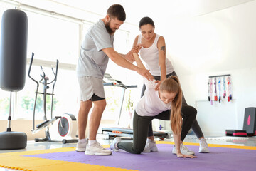 Instructor teaching young women to fight in gym. Concept of self defense