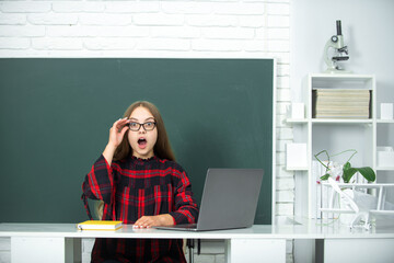 Surprised little student. Portrait of school girl in classroom. School and students in classroom....