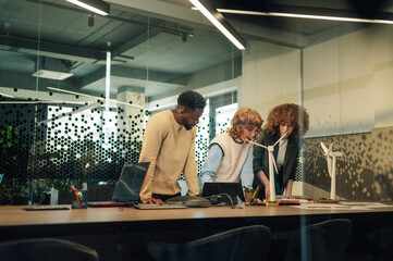 Interracial businesspeople at office working on renewable energy sources
