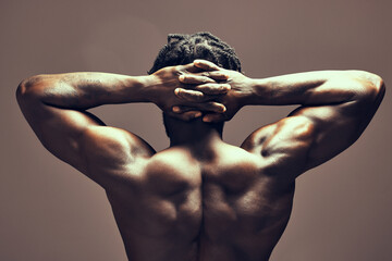 Muscle, skin and black man with fitness, back and bodybuilder on studio background for gym...
