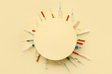 Blank card with medical syringes and ampoules on beige background