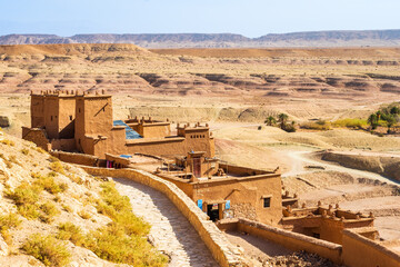 View of Ksar Ait Ben Haddou, old Berber ancient village or kasbah with desert in background,...