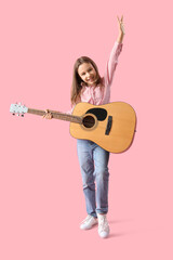 Teenage girl playing acoustic guitar on pink background