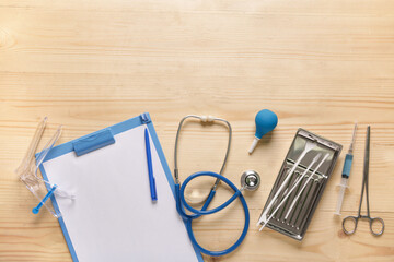 Clipboard with stethoscope, gynecological speculum and pap smear test tools on light wooden...