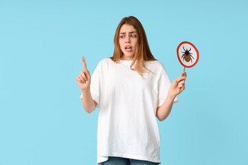 Young woman with dust and mite sign suffering from allergy on blue background
